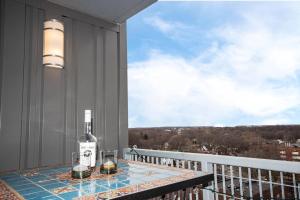a bottle of wine sitting on a table on a balcony at Luxury Condo in Downtown Champaign in Champaign