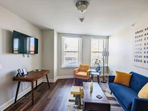 a living room with a blue couch and a table at Stylish 1 BR 1BA at The Inman in Champaign