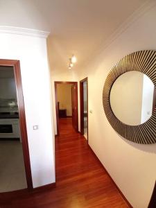 a hallway with a large mirror on the wall at Apartamento Ribeira in Ribeira