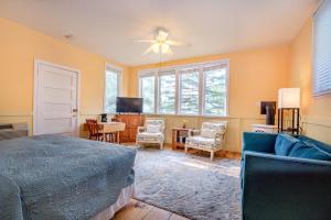 a bedroom with a bed and a living room at White Rose Inns & Motel in Wisconsin Dells