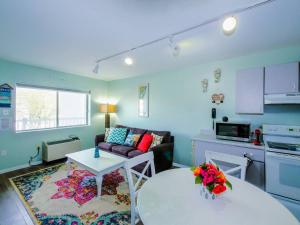 a living room with a couch and a table at Wesley Paradise ☆Chic 1BD + Private Balcony & Pool in Ocean City