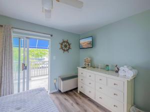 a bedroom with a white dresser and a window at Wesley Paradise ☆Chic 1BD + Private Balcony & Pool in Ocean City