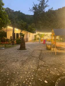 a park with a playground and a building with lights at Maguli Home Gonio in Gonio