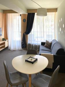 バクリアニにあるRooms Hotel Kokhta Apartmentsのテーブルとソファのあるリビングルーム