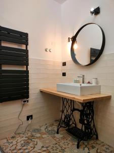 a bathroom with a sink and a mirror at Residenze del Bosco - The Lab in Tuscania