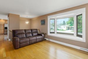 a leather couch in a living room with a window at CozyLiving in Billings