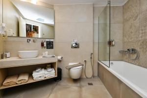 a bathroom with a tub and a sink and a shower at Beach House Palio Damnoni in Damnoni +36 photos