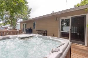 a hot tub on the deck of a house at CozyLiving in Billings