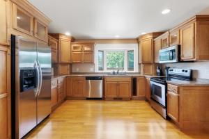 a kitchen with wooden cabinets and stainless steel appliances at CozyLiving in Billings
