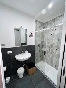 a bathroom with a shower and a toilet and a sink at Civico Sedici in Naples