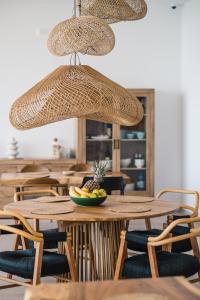 a restaurant with tables and chairs with a bowl of fruit at KAAB Boutique Hotel in Ulcinj