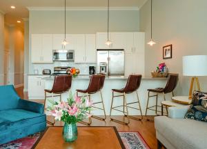 a living room with a blue couch and a kitchen at The Guesthouse Hotel in Chicago