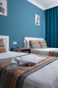 Postel nebo postele na pokoji v ubytování Mavi Yaprak Hotel