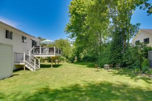 a backyard of a house with a deck and a porch at Narragansett Vacation Rental Near River and Beach! in Narragansett