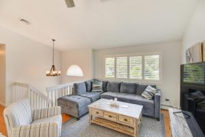 a living room with a couch and a coffee table at Narragansett Vacation Rental Near River and Beach! in Narragansett