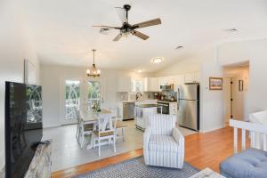 a kitchen and dining room with a ceiling fan at Narragansett Vacation Rental Near River and Beach! in Narragansett