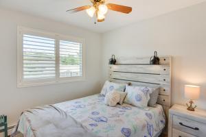 a bedroom with a bed with a ceiling fan and a window at Narragansett Vacation Rental Near River and Beach! in Narragansett