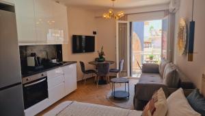 a kitchen and living room with a couch and a table at Luxury apartments in DOWNTOWN of Perea in Perea