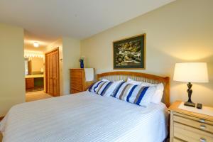 a bedroom with a bed and a lamp on a dresser at Well-Appointed Lincoln Abode Ski, Swim and Fish! in Lincoln