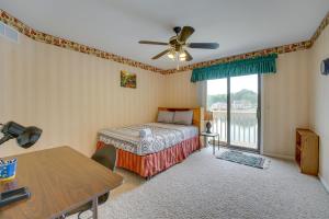 1 dormitorio con cama, mesa y ventana en Spacious Lakefront Getaway with Swim Pond!, en Shelby