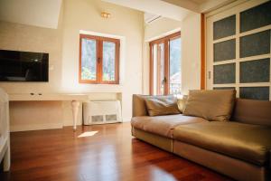 a living room with a couch and a television at Filip Deluxe Rooms in Kotor