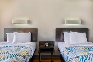 two beds sitting next to each other in a room at Motel 6-Conyers, GA in Conyers