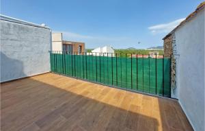 a balcony with a green fence on a building at Gorgeous Home In Ador With Kitchen in Ador