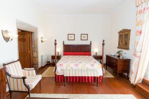 a bedroom with a bed and two chairs in it at Hospedaria do Convento d'Aguiar- Turismo de Habitacao in Figueira de Castelo Rodrigo +46 photos