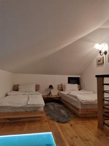 a bedroom with two beds and a swimming pool at KATUN Apartmani & SPA in Divčibare