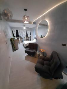 a living room with a couch and a mirror at Design Studio Apartment with balcony and view in central and quiet area in Cali