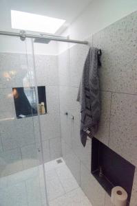 a bathroom with a shower with a glass door at Design Studio Apartment with balcony and view in central and quiet area in Cali +9 photos