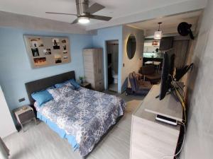 a bedroom with a bed and a flat screen tv at Design Studio Apartment with balcony and view in central and quiet area in Cali