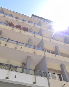 a building with balconies on the side of it at Town Center Apartment in Cagliari