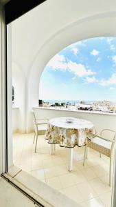 a table and chairs on a balcony with a view at Villa La Zagara by CapriRooms in Capri