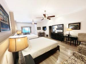 a bedroom with a bed and a living room at Catalina Courtyard Suites in Avalon