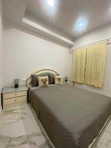 a bedroom with a large bed and a window at Aggelikas apartments in Paleokastritsa