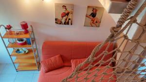 a living room with a red couch and pictures on the wall at Sea Mona in Tivat