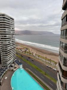 a view of the beach from the balcony of a building at Departamento con vista al mar in Iquique