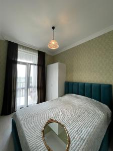 a bedroom with a large bed with a mirror on it at Green house - Apartment 1g - 17 in Rustavi