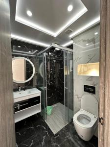 een badkamer met een douche, een toilet en een wastafel bij اقامة الانوار in Nador