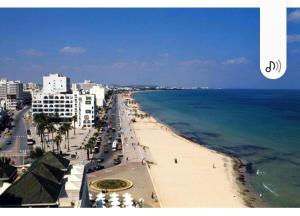 a view of a beach with the ocean and buildings at Apparts MT in Sousse