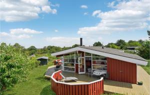 a house with a deck with a van parked in it at 4 Bedroom Lovely Home In Hundested in Hundested