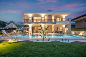 a villa with a swimming pool at night at Enclave Villa Luxury,Pool and Nature at Marmaris in Marmaris