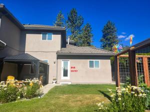 a house with a entry sign on the side of it at 1 BDRM 1 BTH Suite with Private Entry in West Kelowna