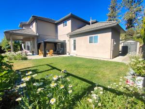 a house with a yard with flowers at 1 BDRM 1 BTH Suite with Private Entry in West Kelowna