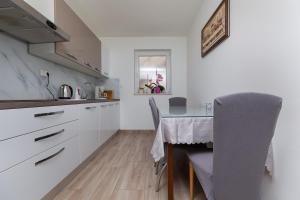 a kitchen with a table and a dining room at Apartments with parking space Stanici, Omis - 11421 in Celina +14 photos