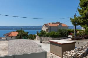 a view of a house and the water at Apartments with parking space Stanici, Omis - 11421 in Celina