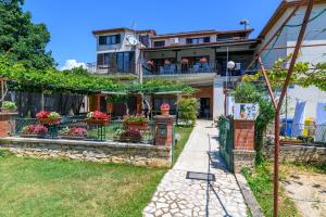 a house with flowers in a yard at Apartments by the sea Banjole, Pula - 3002 in Pula