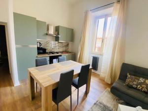 a kitchen and dining room with a table and a couch at A Casa Lucia in Montefiascone