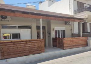 a wooden fence on the side of a house at Nikolettas Studios Traditional House in Paradeísion